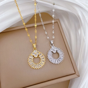 Macro shot of gold and silver four-leaf clover necklaces with sparkling cubic zirconia