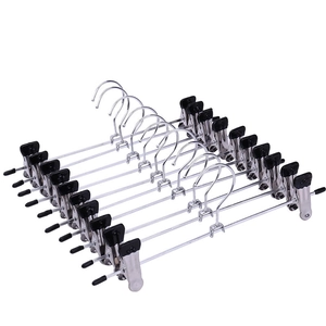 Set of 10 non-slip stainless steel pants hangers with black clips for closet storage