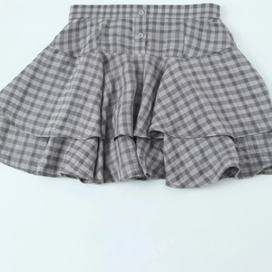 Fashionable grey plaid tiered mini dress with decorative buttons and layered skirt