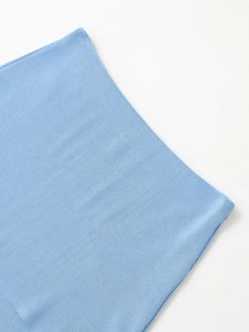 Close-up of sky blue fine knit denim fabric texture with detailed weave pattern