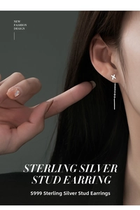 Detail of S999 sterling silver X-shaped drop earring worn by a model in a minimalist style