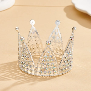 Detailed view of silver birthday cake crown with sparkling rhinestones and hollow design