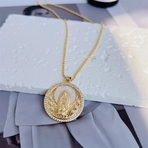 Detail view of 18k gold plated Virgin Mary pendant with pearls and zircon inlay