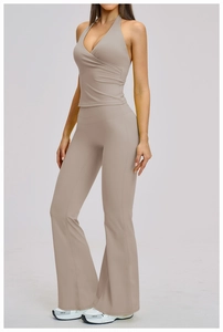 Detail of high-waist flared yoga pants and halter wrap top in matte taupe fabric