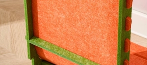 Close-up of thick felt cat scratcher featuring vibrant orange and green interlocking panels