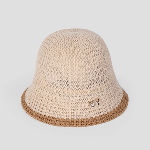Close-up of beige knit bucket hat with brown brim and golden bow metal buckle detail