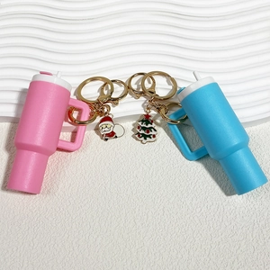 Detail of Christmas themed silicone water bottle keychain with Santa and tree charms