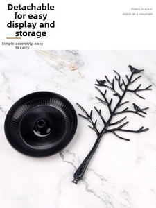 Macro view of detachable black tree-shaped jewelry organizer with round display tray