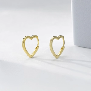 Detailed view of polished S925 sterling silver heart-shaped hoop earrings in gold finish