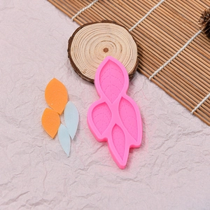 Pink silicone leaf mold for chocolate and baking decorations with four leaf cavities