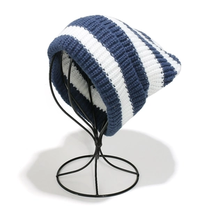 Close-up detail of blue and white striped knit beanie with thick woolen texture
