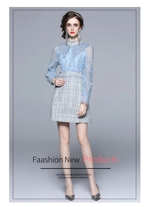 Detail of light blue lace collar and tweed texture on elegant two-piece dress