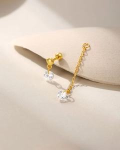 Close-up of golden S925 silver heart stud with sparkling zircon chain and marquis stones