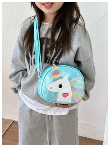 Detail view of the bright blue unicorn crossbody bag with a rainbow tulle mane and pink heart