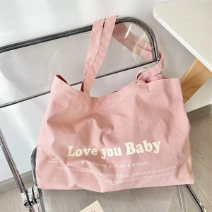 Detail of pink canvas tote bag with Love you Baby print and large capacity design