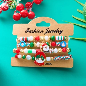 Detail view of 4-piece Christmas beaded bracelet set with Santa and snowman charms