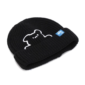Detail of bear embroidery and side blue woven label on black knit beanie hat