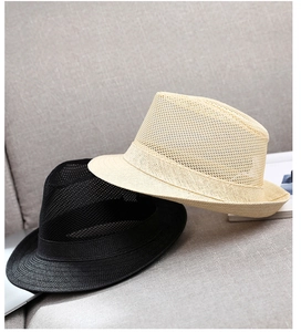 Close-up of mesh breathable straw fedora hats in beige and black for summer sun protection