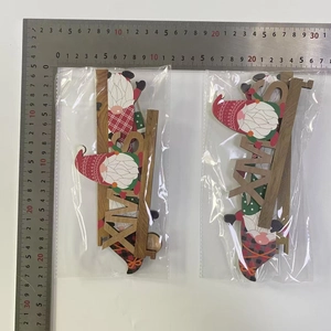 Macro shot of wooden XMAS signs featuring gnomes and red-green plaid Christmas patterns