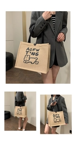 Detail view of the linen tote bag featuring a black handle and a cute rabbit print design