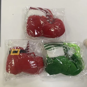 Close-up of three festive Christmas table leg covers in red and green striped plush fabric
