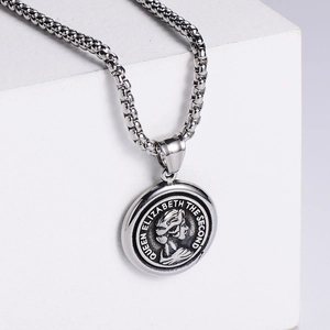 Macro view of silver Queen Elizabeth II coin pendant on geometric pedestal