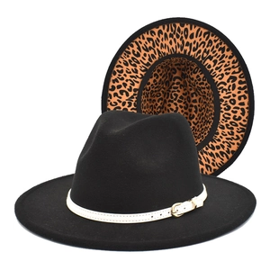 Detail of black wool fedora featuring leopard print brim lining and white buckled belt