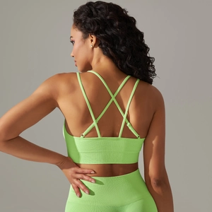 Detail of neon green seamless sports bra with criss-cross back straps and ribbed texture
