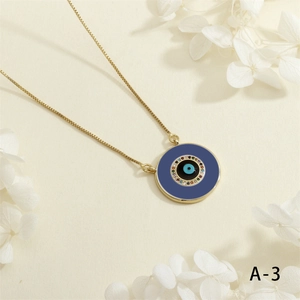 Detailed close-up of golden Evil Eye pendant with colorful zircon and enamel inlay