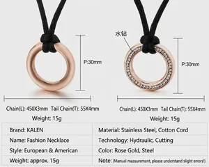 Detail view of round stainless steel pendants with rhinestones and black cord necklace