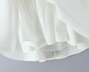 Detailed close-up of white French style dress showing fine sewing and double-layered fabric