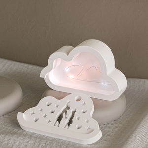 Detail of cloud-shaped night light featuring a hollow reindeer silhouette and LED copper lights