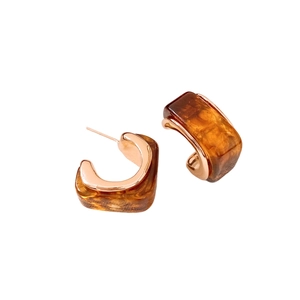 Retro amber resin C-shape hoop earrings with rose gold metal inlay on white background