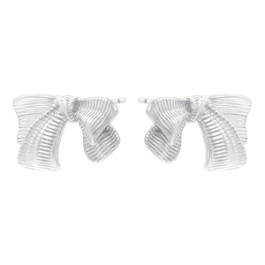 Detailed view of silver bow stud earrings featuring brushed metal stripes and textures