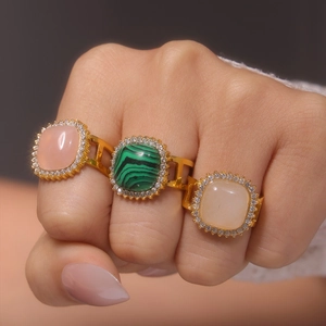 Three gold PVD coated steel rings with pink green and beige square stones for women