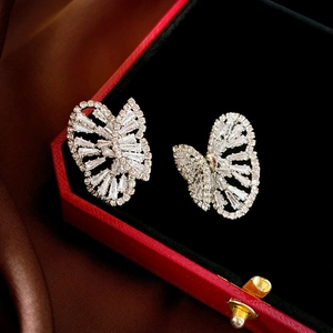 Macro shot of silver butterfly earrings with cubic zirconia in a velvet gift box