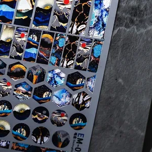 Metallic gold nail stickers with mountain and starry sky patterns on black background