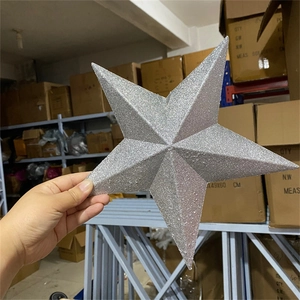 Close-up of a silver glittered Christmas tree topper star in a storage warehouse