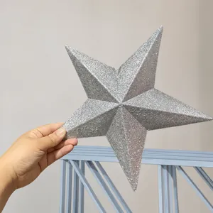 Close-up of a silver glittered Christmas tree topper star in a storage warehouse