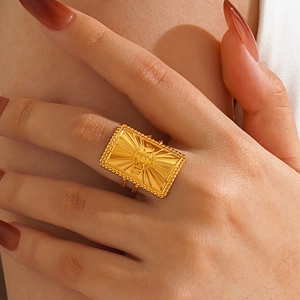 Minimalist gold LUCKY rectangular ring with adjustable band shown on a hand