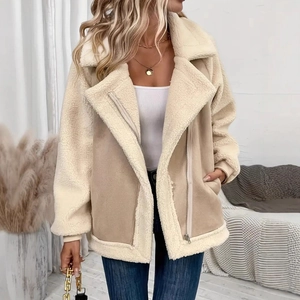 Detail of faux shearling collar and suede texture on beige biker jacket with silver zipper