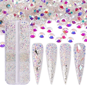 Macro view of assorted AB crystal nail art rhinestones with organized storage box