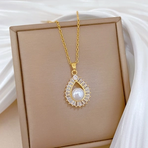 Detailed view of teardrop pearl pendant with zircon halo on gold titanium steel chain