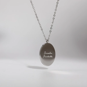 Detailed shot of silver stainless steel December Poinsettia pendant and fine chain