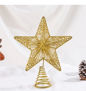 Close-up of golden Christmas tree topper star with glittery finish and spiral base