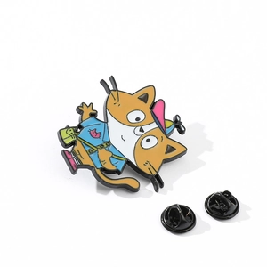 Detail of cartoon cat enamel pin with vibrant colors and two black butterfly clutch backings