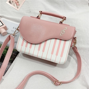 Pink and white piano keyboard crossbody handbag with treble clef and gold hardware