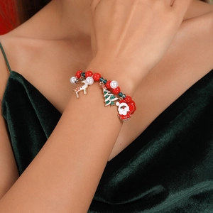 Detailed view of Christmas beaded bracelet with Santa, reindeer and tree charms on wrist
