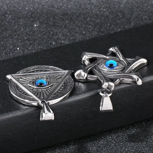 Macro view of vintage stainless steel pendants with blue evil eye in star and triangle shapes