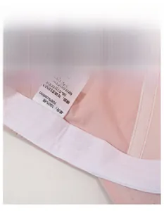 Detail view of pink cotton sun hat featuring wide sweatband and adjustable size label
